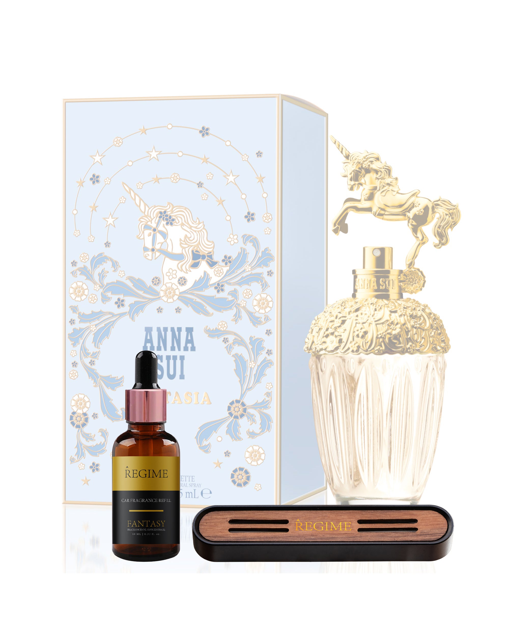 A faded background featuring Anna Sui perfume for women; in the front, a fragrance oil dropper bottle inspired by Anna Sui and a Regime Fragrances car vent clip with a black charcoal metal exterior and a inserted wooden front panel for fragrance spreading.